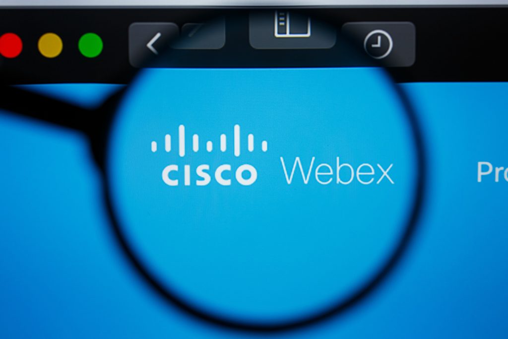 'Cisco Webex' being Magnified by a magnifying glass zooming into the words on a web page opened up on a laptop to suggest one is researching A Guide to Cisco Webex